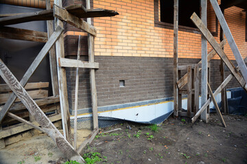 Damaged foundation waterproofing of a house under construction. Badly installed dimpled waterproof,...