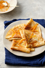 Crepes suzette with orange sauce and zest.