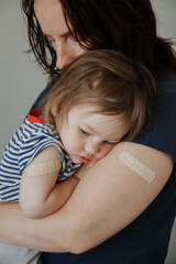 mother and daughter, a child after vaccination. A child with poor health and a high temperature.
