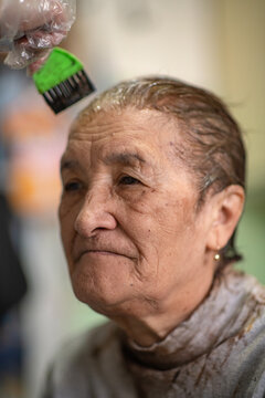 An Elderly Woman Has Her Hair Dyed At Home.