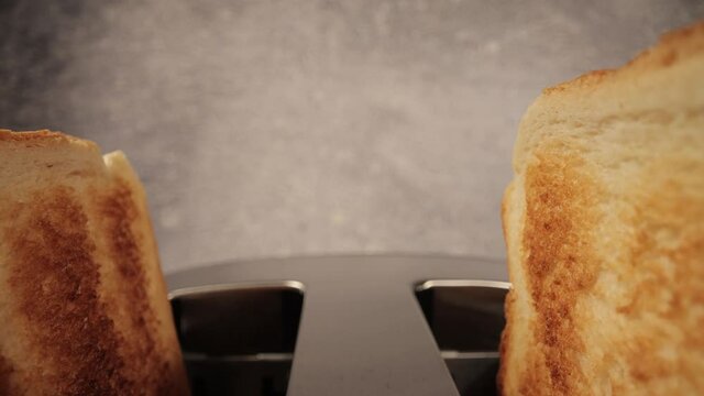 Toasted bread jumps out of a toaster - close-up shot - food photography
