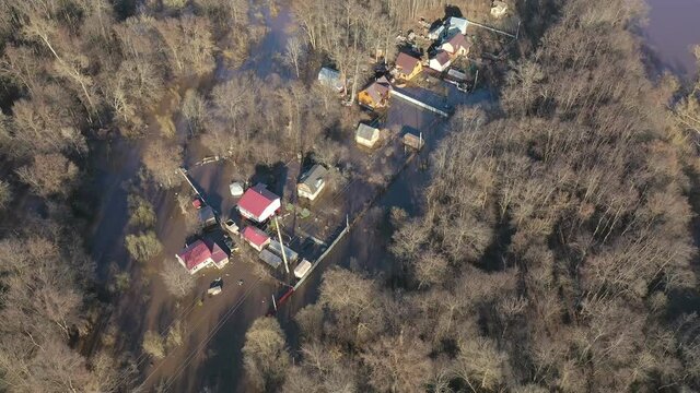 Aerial photography in motion. View over houses flooded with water among the forest . Seasonal Wetlands - an overview. 4k footage.