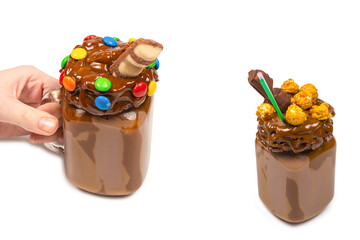 Chocolate milkshake with whipped cream, cookies, waffles, served in glass mason jar. 