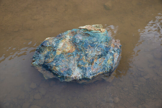 Natural stone with multple colors inside water pond