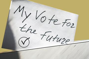 white paper with "My vote for the future" inscription dropped in a white box. ballot paper for election vote concept.
