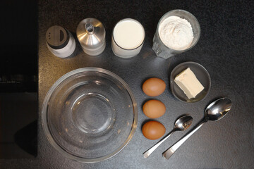 Making pancake dough. The ingredients on the table are wheat flour, eggs, butter, sugar, salt, milk. Maslenitsa.