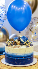 Handmade birthday cake on a blurred background with balloons and sparkles. Cheesecake cake, blue and gold accents. Festive background for postcard, holiday, birthday, anniversary, 18 years. 