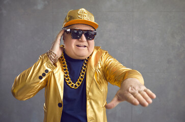 This is the rhythm of my life. Funny rich senior man playing music at disco party. Studio portrait...