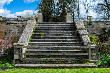 View of the big stairs, greenery, flowers, trees in the Easton Walled Gardens in UK.