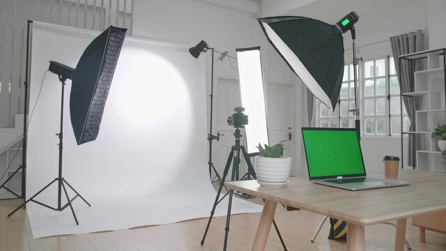 Photo Studio With Professional Equipment And Green Screen Laptop Computer Display
