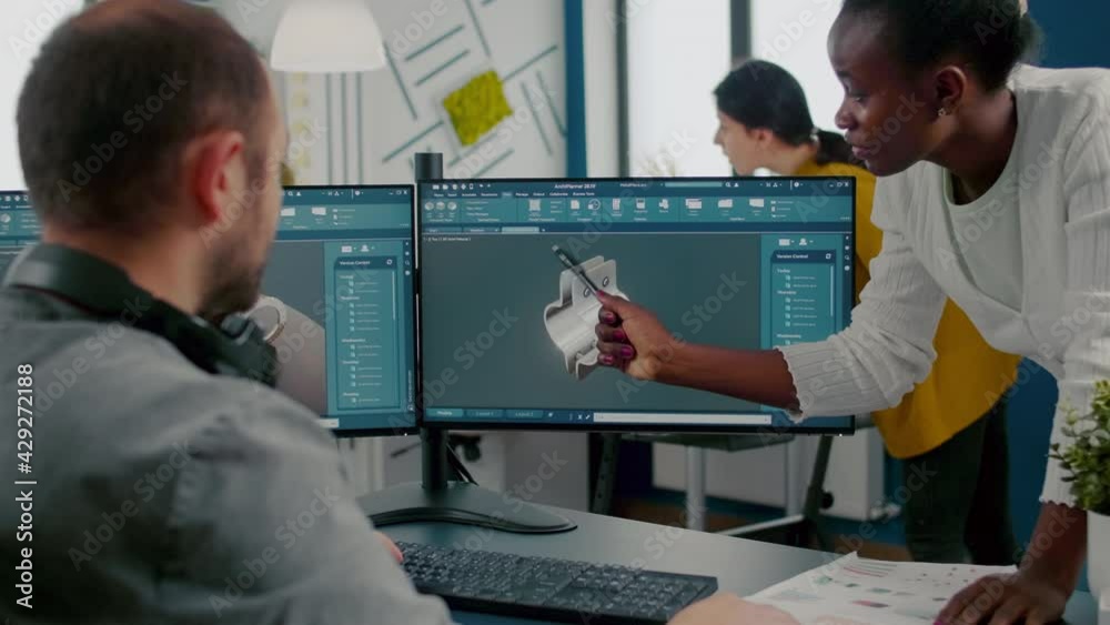 Poster black employee pointing on monitor explaining to project manager mechanical metalic parts of motor p