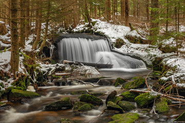 Waterfall on Jezerni creek in spring in national park Sumava in Czech republic