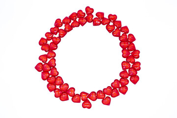 Bright red hearts are shiny, glass lie in the form of a round frame on a white background. Concept of love, marriage, wedding, Valentines day, passion