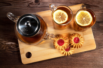 Fototapeta na wymiar tea in a cup with lemon on the background