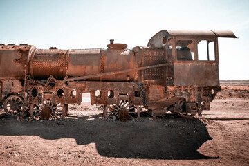 Fototapeta na wymiar Old rusty steam train near Uyuni in Bolivia. Cemetery trains.