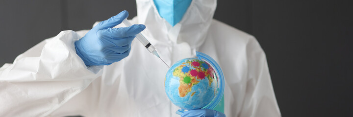 Doctor in anti-plague suit making injection into globe