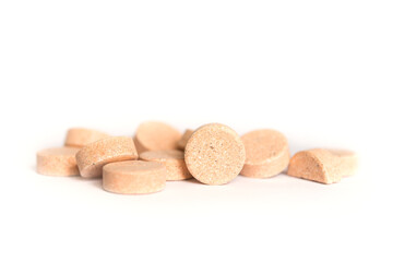 Colored pills on a white background. Round herbal tablets close-up. Healthcare and medicine.