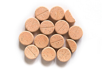 Colored pills on a white background. Round herbal tablets close-up. Healthcare and medicine.