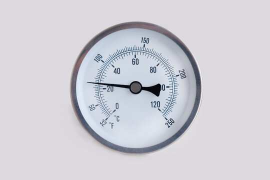 Round thermometer, 25 degrees Celsius and 65 degrees Fahrenheit. cool metal air temperature 