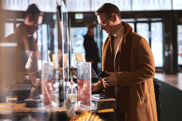 Handsome businessman in Hotel check in at reception or front office being given key card
