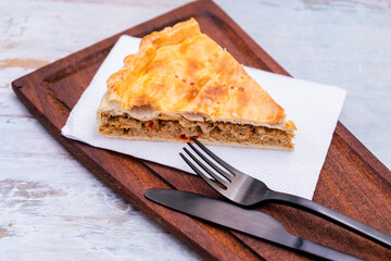 Portioin of Empanada Gallega, traditional plant of Galician cuisine, in Spain, Tart with tuna and vegetables. Traditional cuisine.