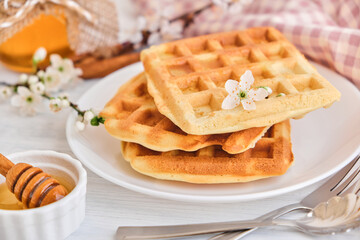 Honey pouring on a fresh Belgian waffles.