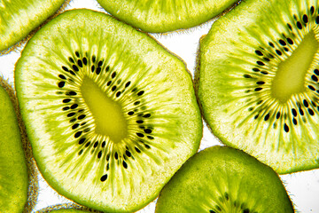 Kiwi slices translucend on a bright white background