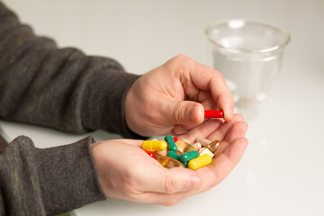 Man holding pills and vitamins