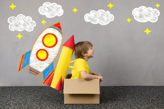Happy kid dreams about space. Imagination, freedom and motivation concept