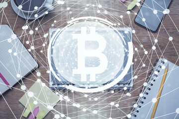 Double exposure of blockchain theme hologram over table with phone. Top view. Crypto technology concept.