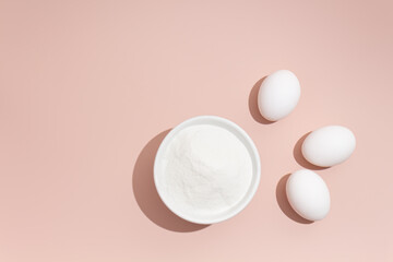 collagen and eggs on a pink background
