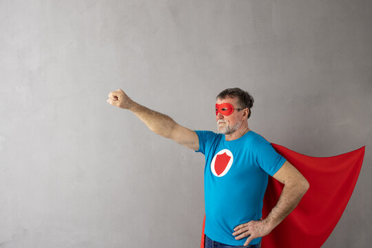 Senior man wearing superhero costume