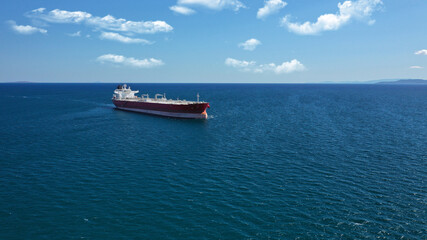 Aerial drone photo of crude oil super tanker cruising in low speed in deep blue sea of Saronic gulf near port of Piraeus, Attica, Greece