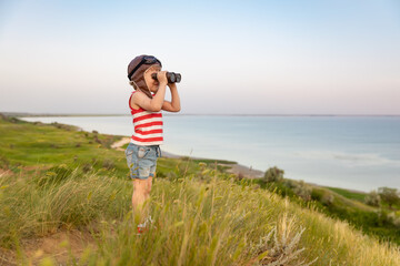 Happy child against blue sea and sky background