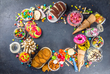 Selection of colorful sweets. Set of various candies, chocolates, donuts, cookies, lollipops, ice cream top view on black concrete background