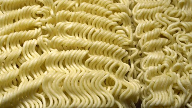 Instant noodles.
Close up of raw dried noodles.
Uncooked noodles texture.
Precooked dehydrate&nbsp;noodle&nbsp;blocks.&nbsp;
Asian food. Food background.
