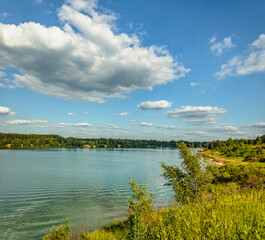 Summer vacation on the banks of an old quarry with turquoise water.