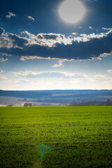 tillage in early spring. Tractor with aggregate