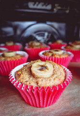 homemade healthy oat muffins with banana piece on the top in the oven