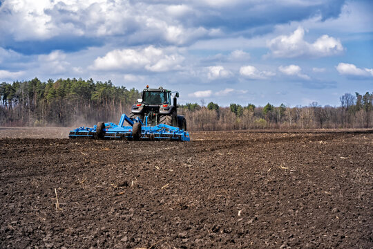 Tillage In Early Spring. Tractor With Aggregate