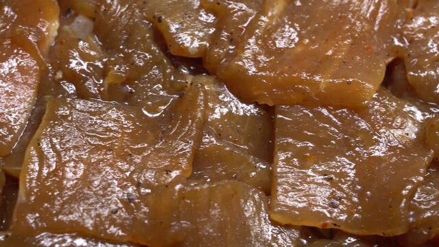 Thinly cut, skinless raw chicken meat ready for a stir-fry. Uncooked, marinated in soy sauce and spices.
Chinese food. Close up. Food background.
Rotation.