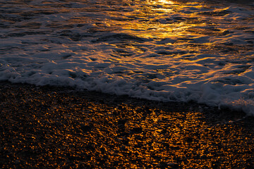 sea ​​foam during an orange sunset