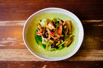 Fried Shiitake Mushroom Salad with Cucumber Water. Pan-Asian oriental cuisine on wooden table.