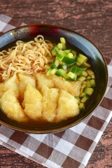 Pempek or mpek-mpek, popular savory fish cake dish from Palembang, South Sumatra, Indonesia. Served in sweet and sour sauce (kuah cuka) accompanied with noodles, cucumbers