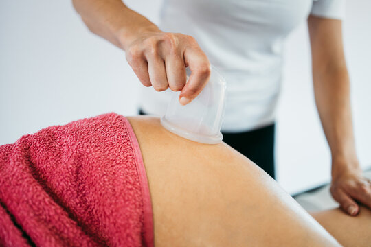 Middle age woman at professional anti cellulite massage with Ventuza vacuum body puller. Close up shot.