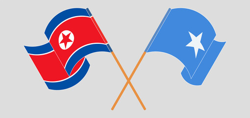 Crossed and waving flags of North Korea and Somalia