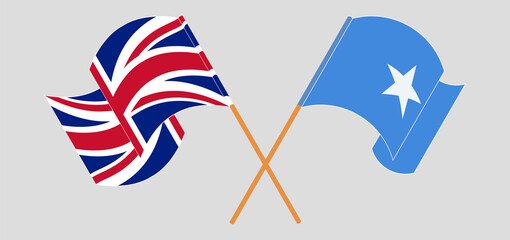 Crossed and waving flags of the UK and Somalia