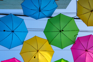 Colorful umbrellas hanging above an alley in Redlands, California.