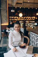 Young lady browsing the Internet at the cafe