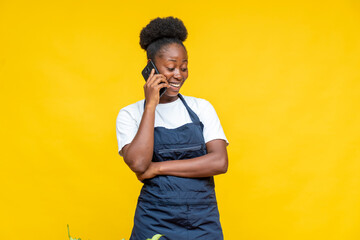 excited female african chef making a phone call